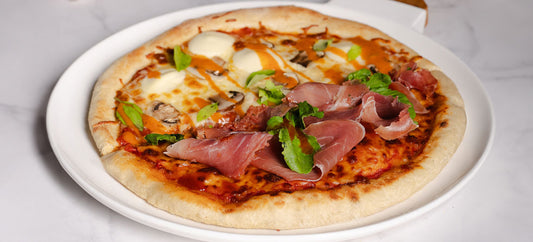 Mushroom Pizza with Truffle Sauce, Prosciutto, and Arugula